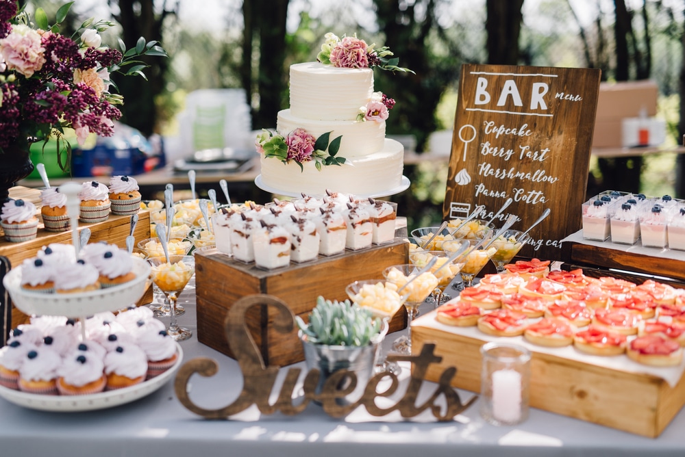 Candy,Bar.,White,Wedding,Cake,Decorated,By,Flowers,Standing,Of